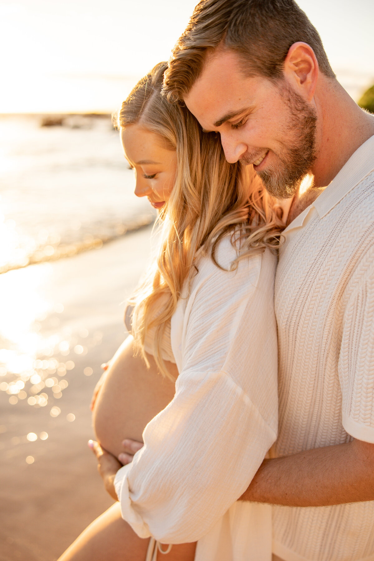 Maui Couples Photographer captures man holding woman's belly during beach maternity photos