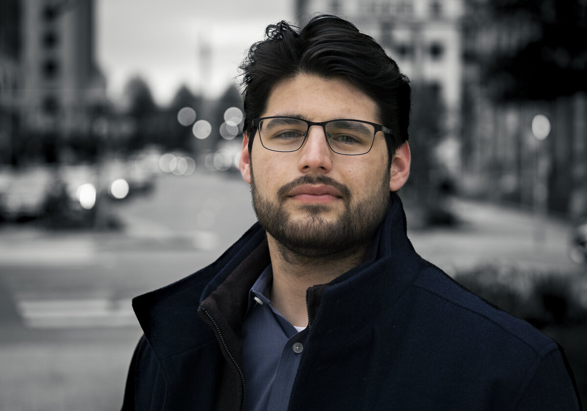 Headshot of a man in downtown Buffalo with a black and white background