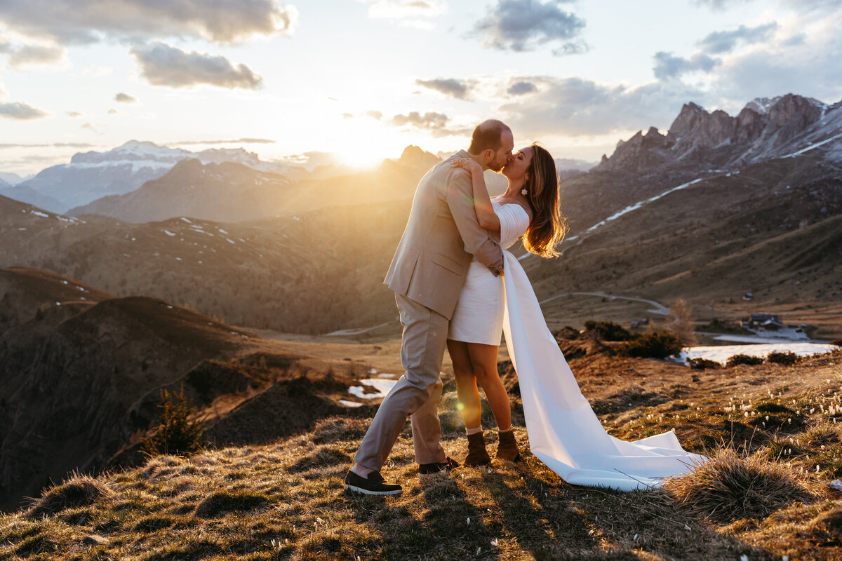 romantic couple kissing during twilight elopement in Dolomites