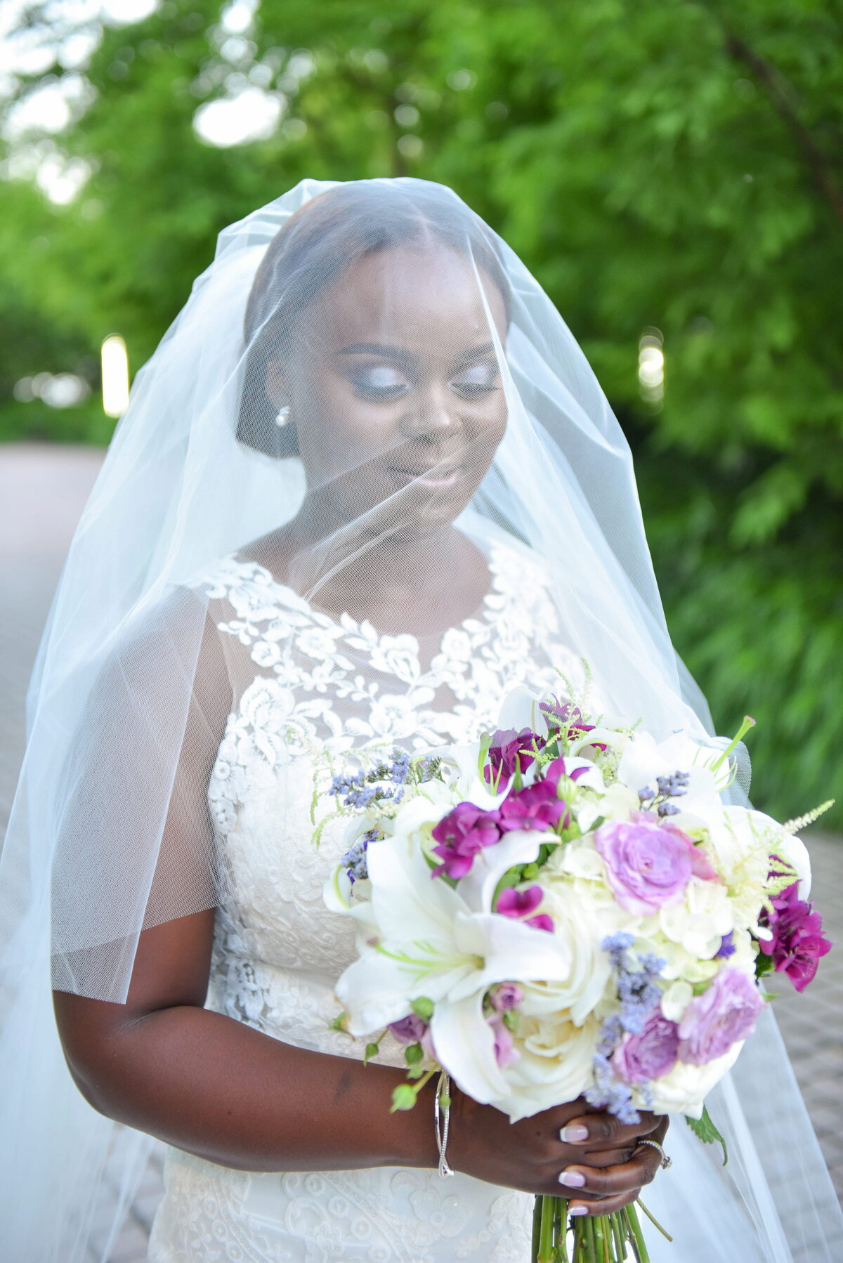 Bride in Veil with Beautiful Wedding Bouquet