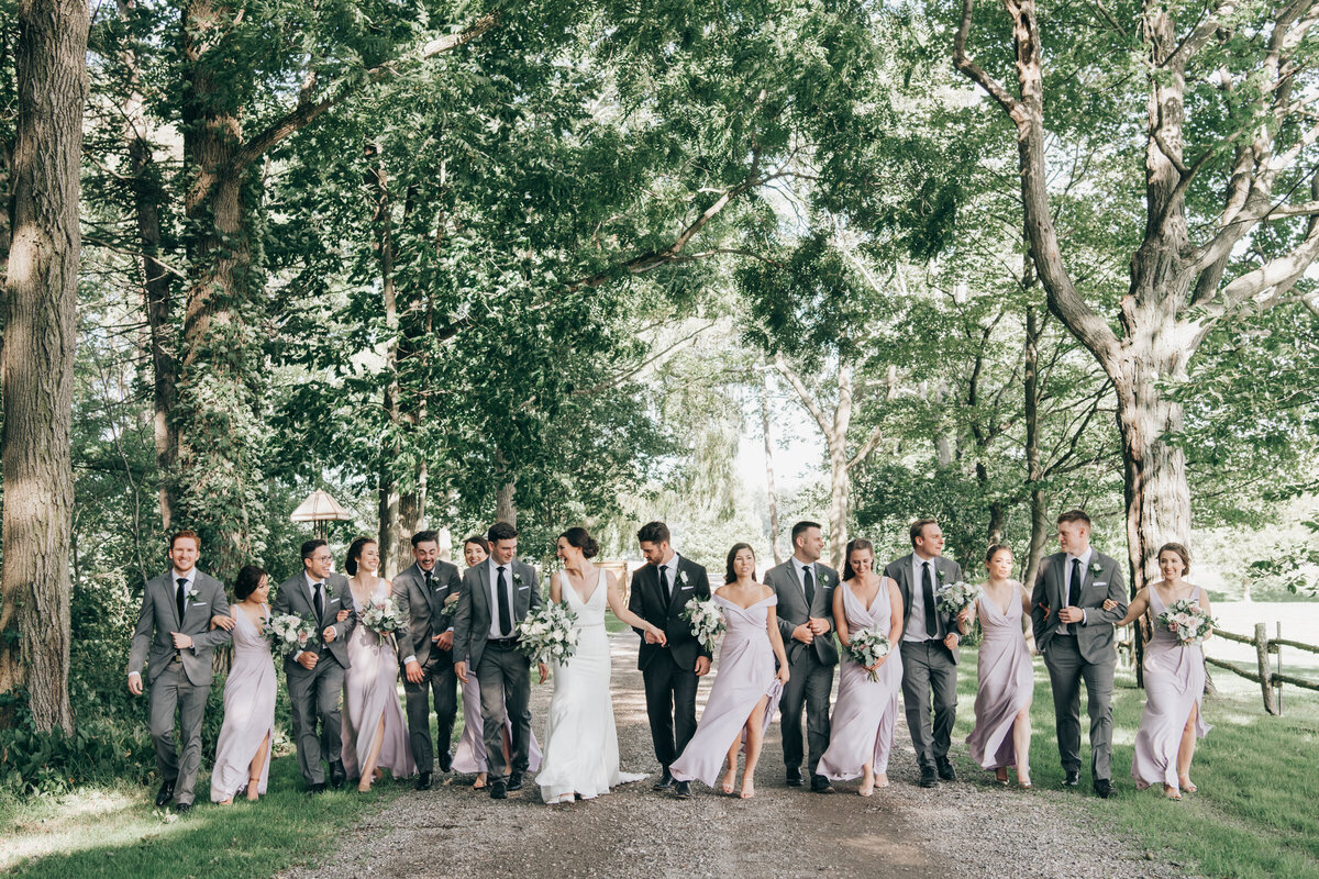 Wedding party wearing. lavender and grey walking and having fun on the wedding day