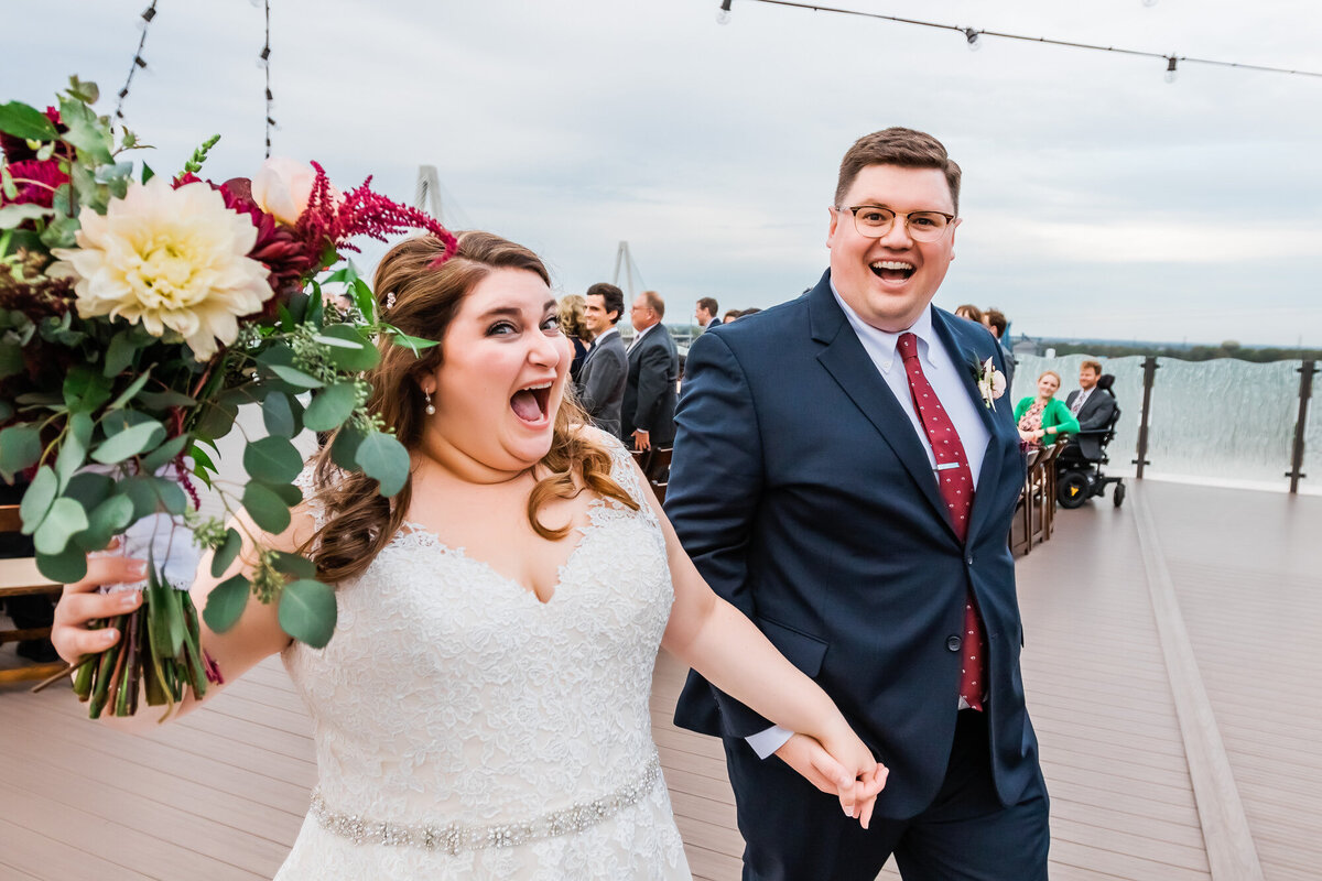 Bride and groom celebrating during their recessional at their wedding ceremony