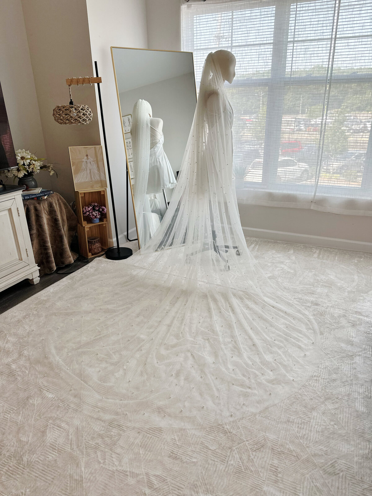 Bride styled with soft beaded veil and loose romantic waves

