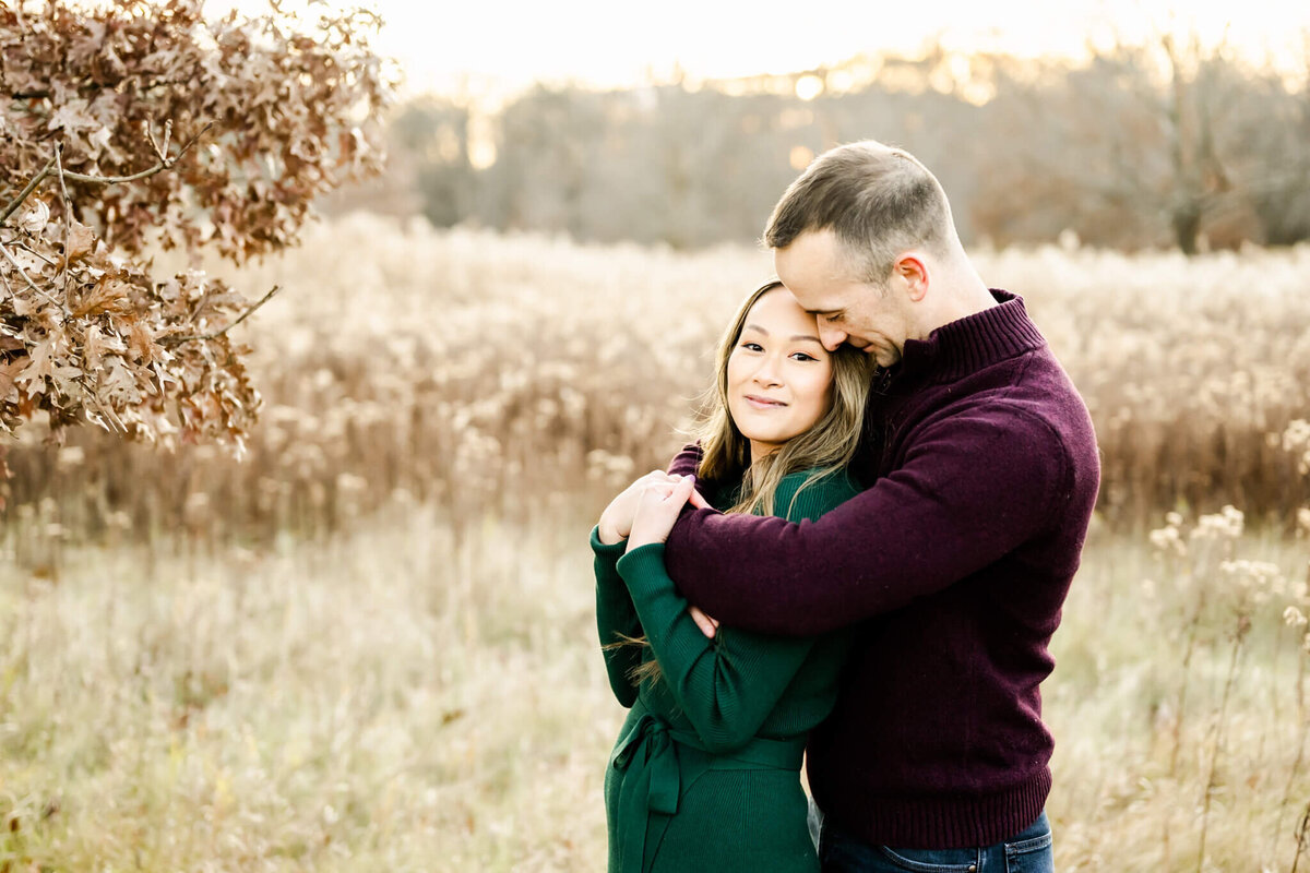 Stunning married couple embrace at fall couples session near Chicago, IL.