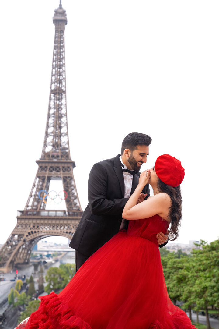Candid laughing couple moment Paris, authentic joy capture, Eiffel Tower background