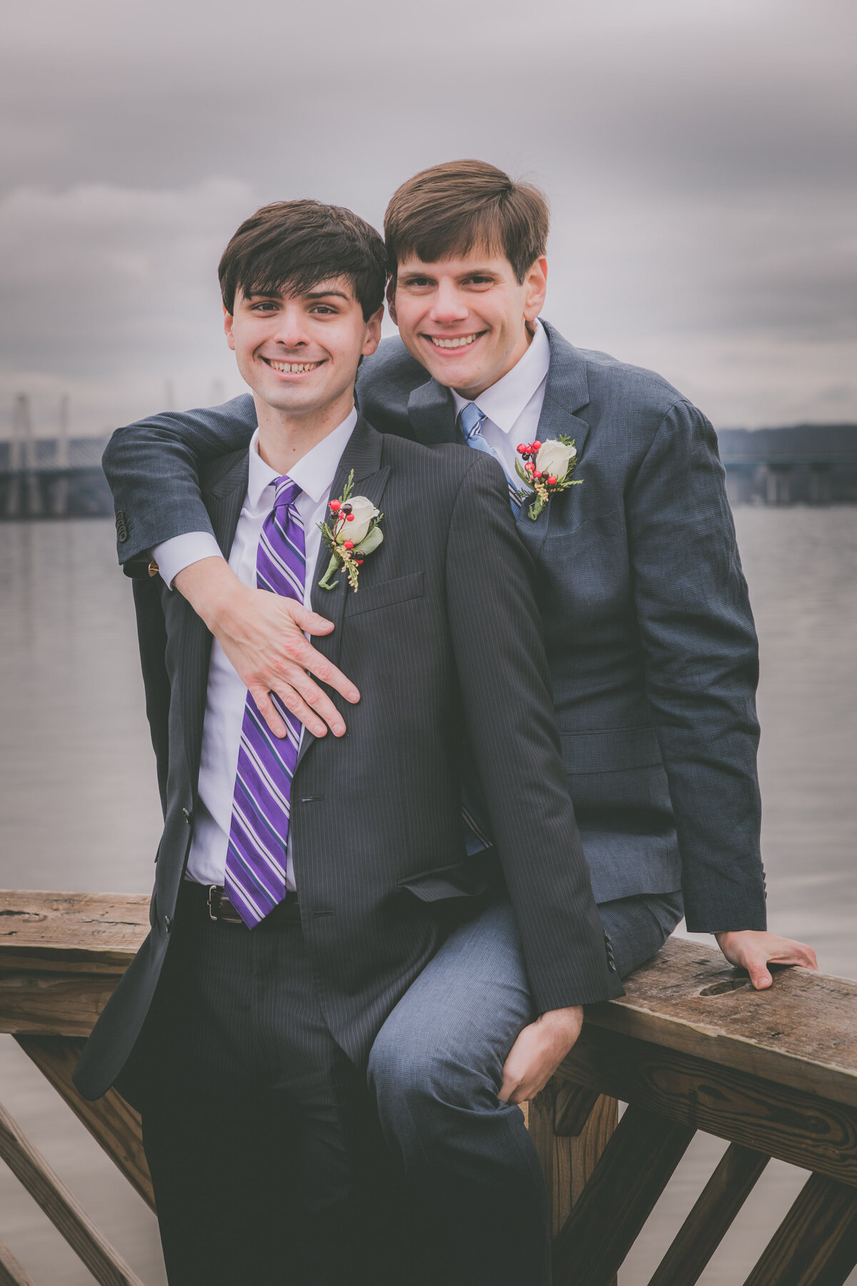 Two grooms pose for a portrait.