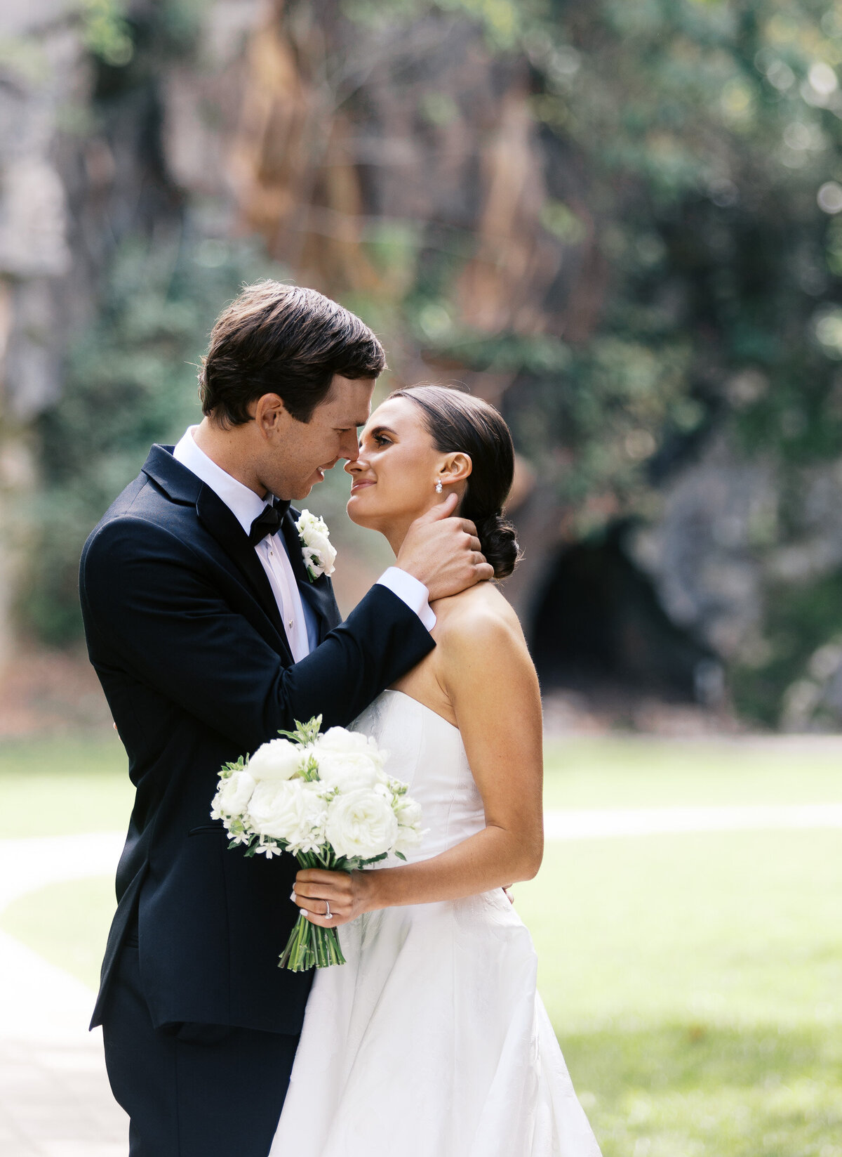 Bride and Groom touching their noses to each other as they are about to kiss