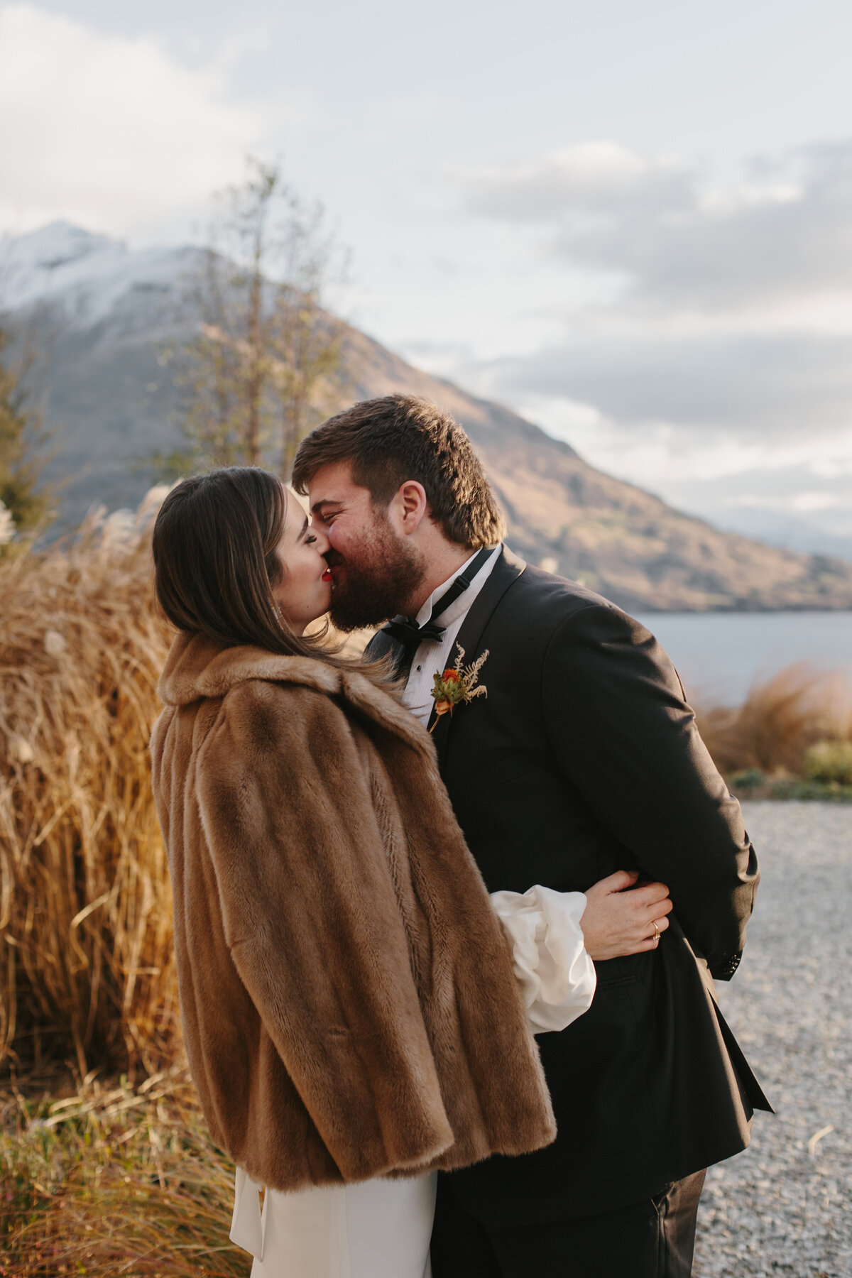 The Lovers Elopement Co - bride and groom kiss after wedding ceremony in Queenstown
