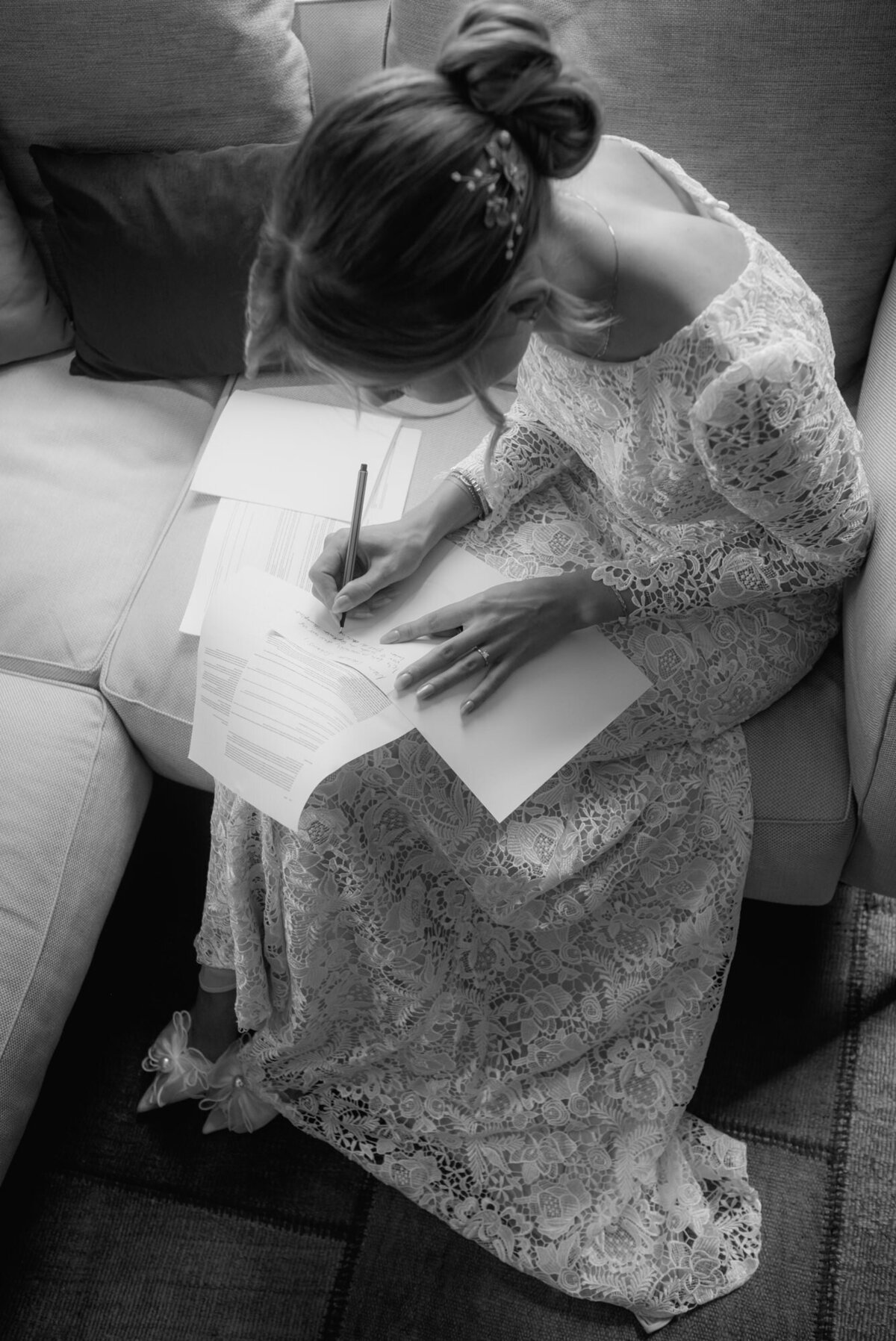 Candid moment when bride finalizes her wedding vows during getting ready session.