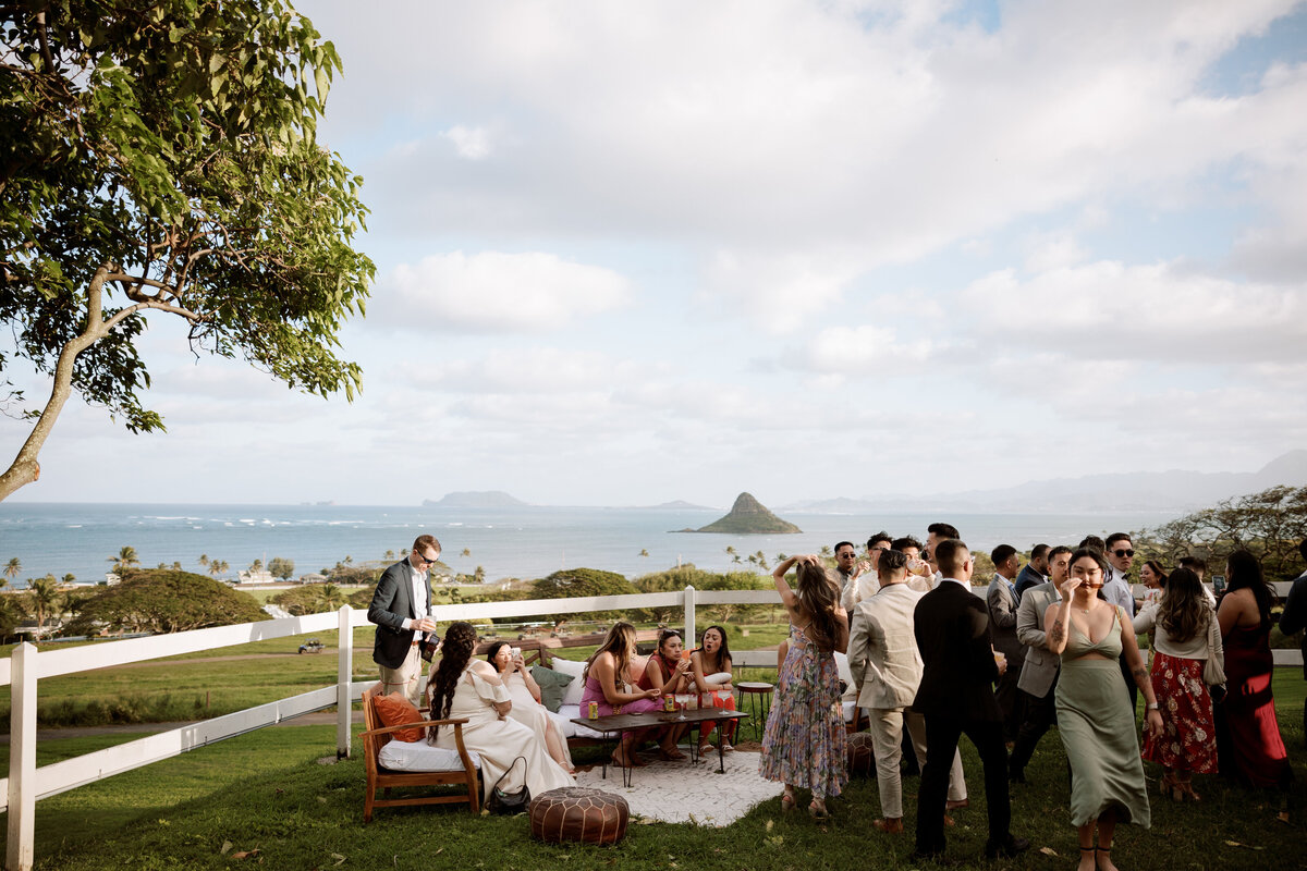 Stunning landscape of the reception at Kualoa Gardens on Oahu, captured in a destination wedding photography style — Carmel wedding photography by Kate Winters Photography.