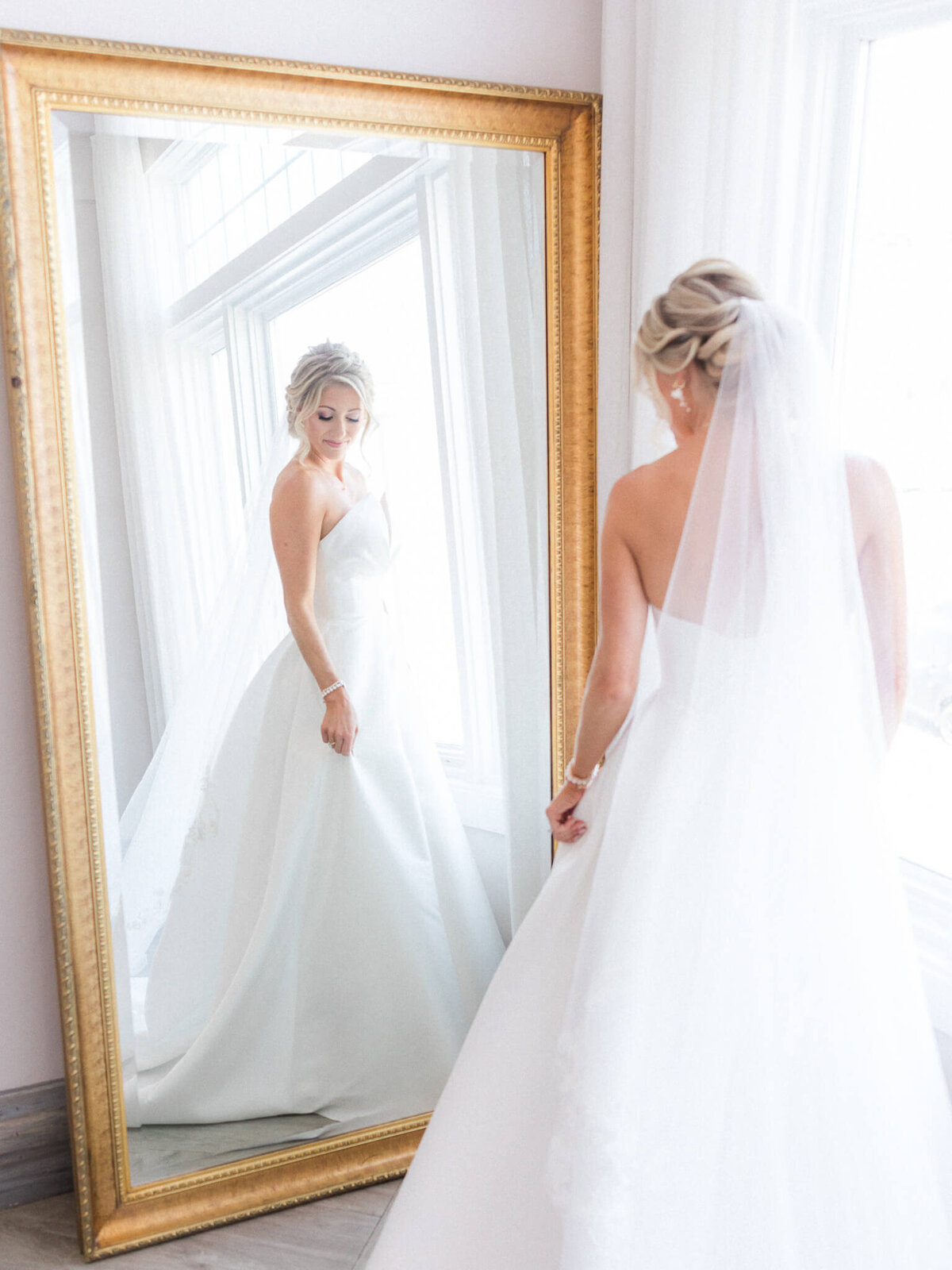 bride looking in mirror at newport beach house, middletown RI