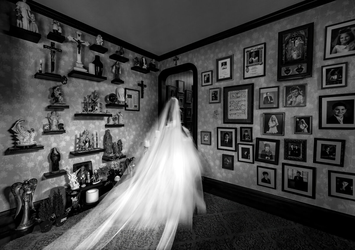 A bride is surrounded by her grandmother's religious icons as she leaves the room.