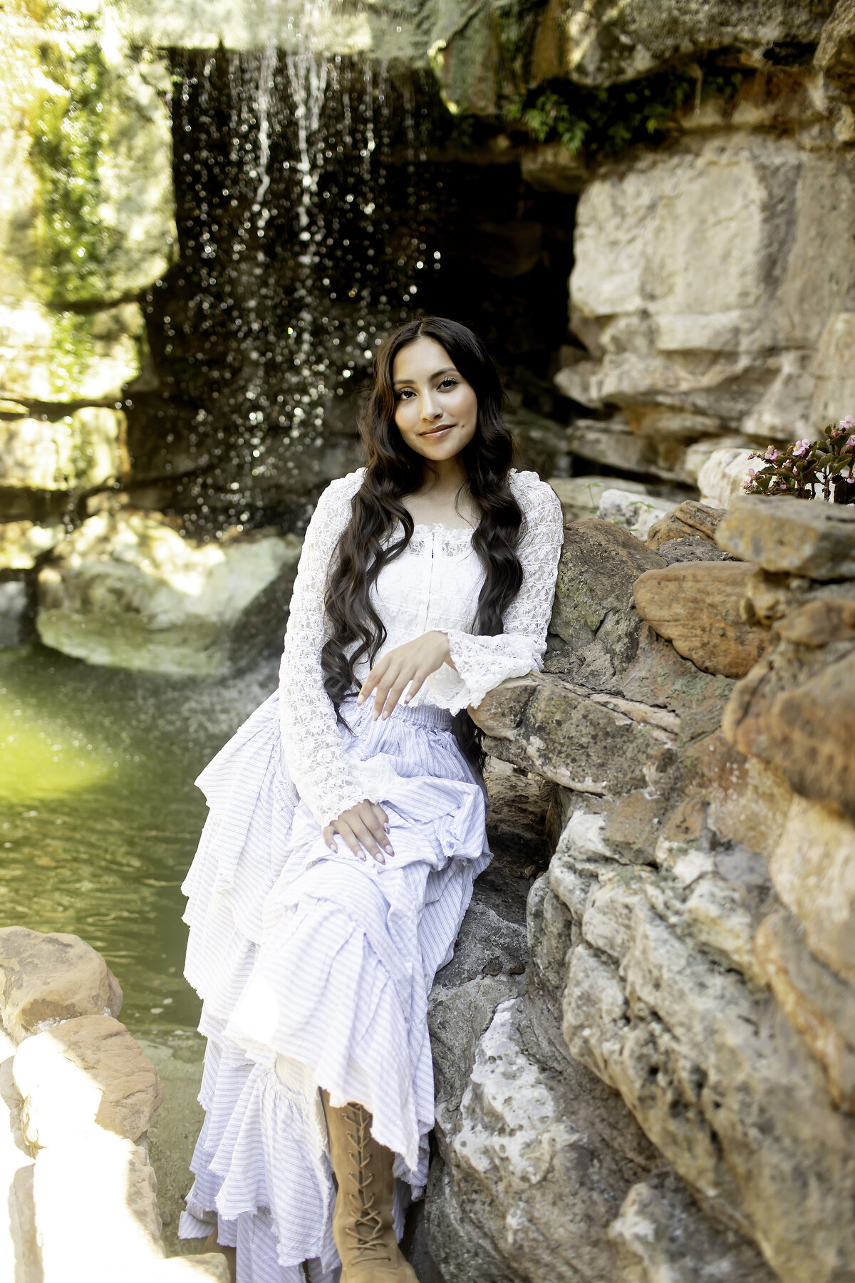 A stunning senior photoshoot in the tranquil setting of Chandor Gardens, with the graduate glowing in a soft, flowing dress against a backdrop of blooming flowers