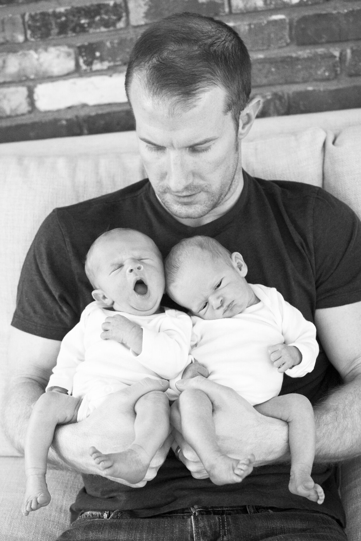 Dad holding twin baby boys Asheville newborn photography at home
