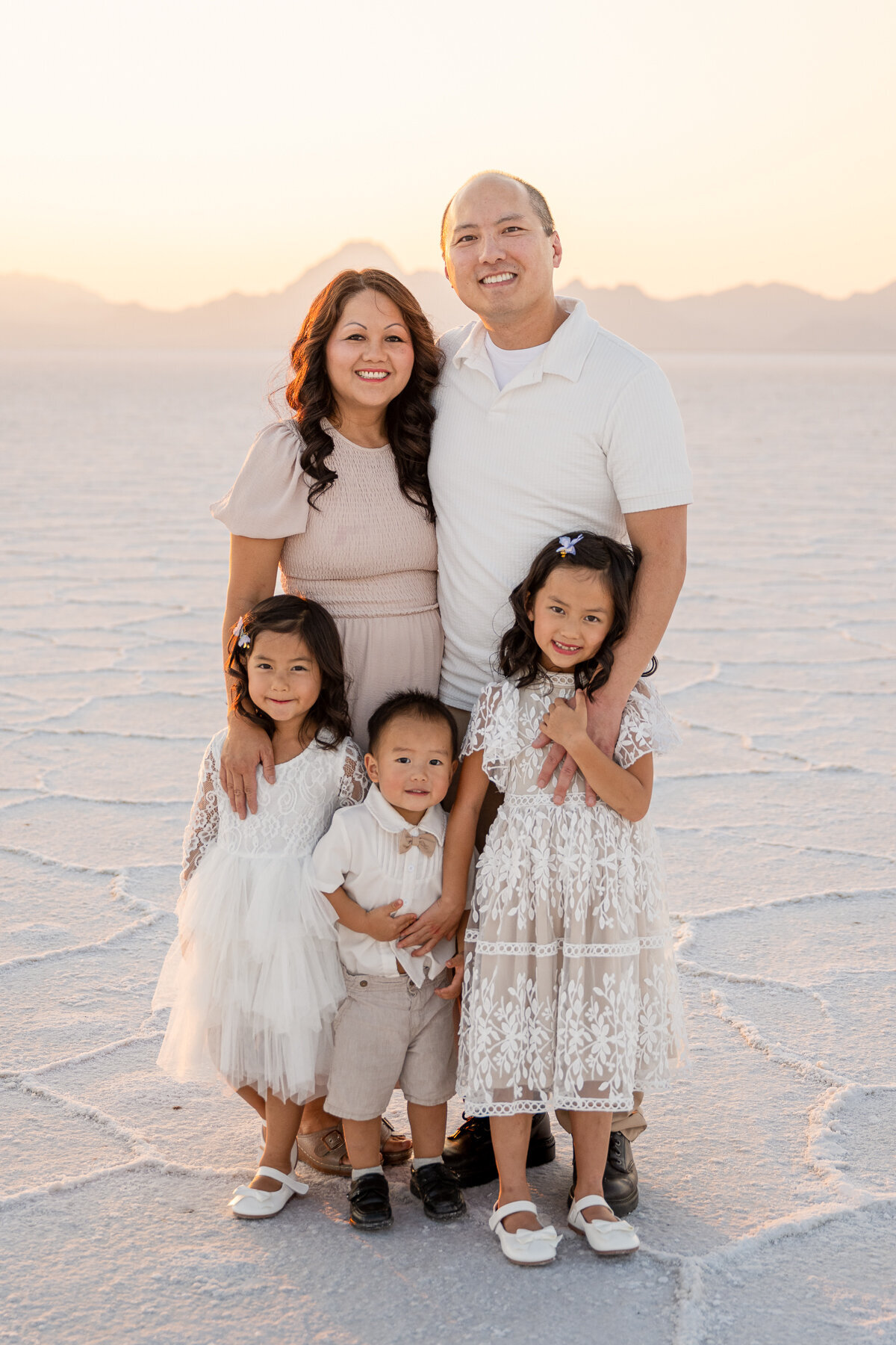 aisian family standing at the salt flats utah for family photos 