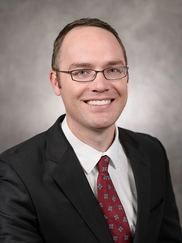 Traditional headshot of man in suit