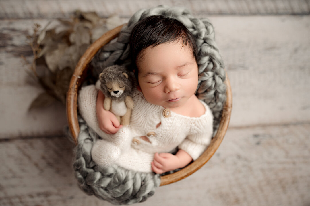Grand Rapids Newborn Photography Baby wearing knitted clothes by For the Love of Photography