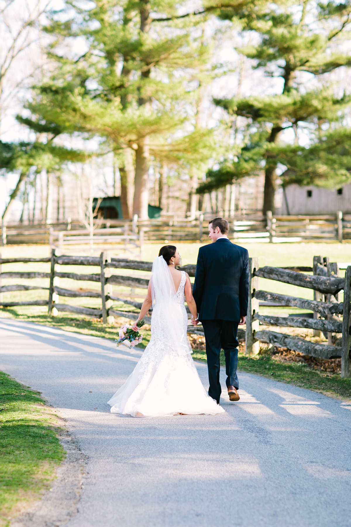 bride and groom walking at the stamford museum and nature center