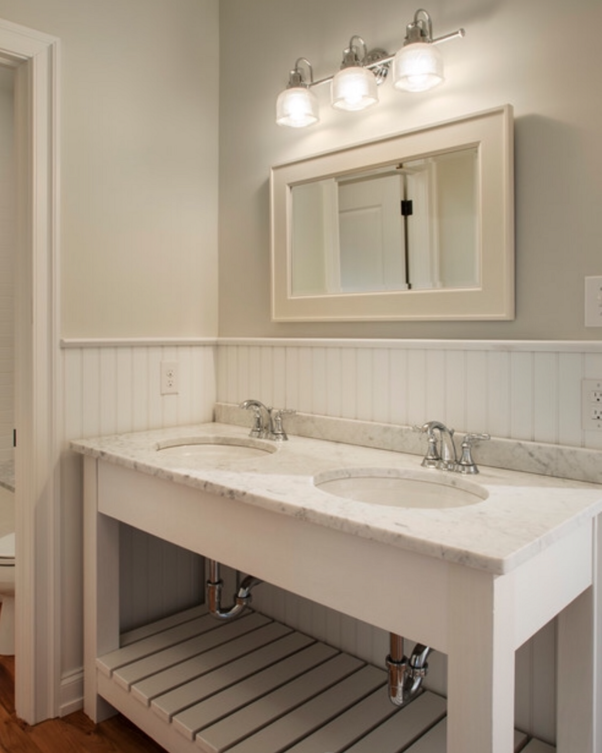 Vintage vanate, white counter tops stainless steel fixtures 