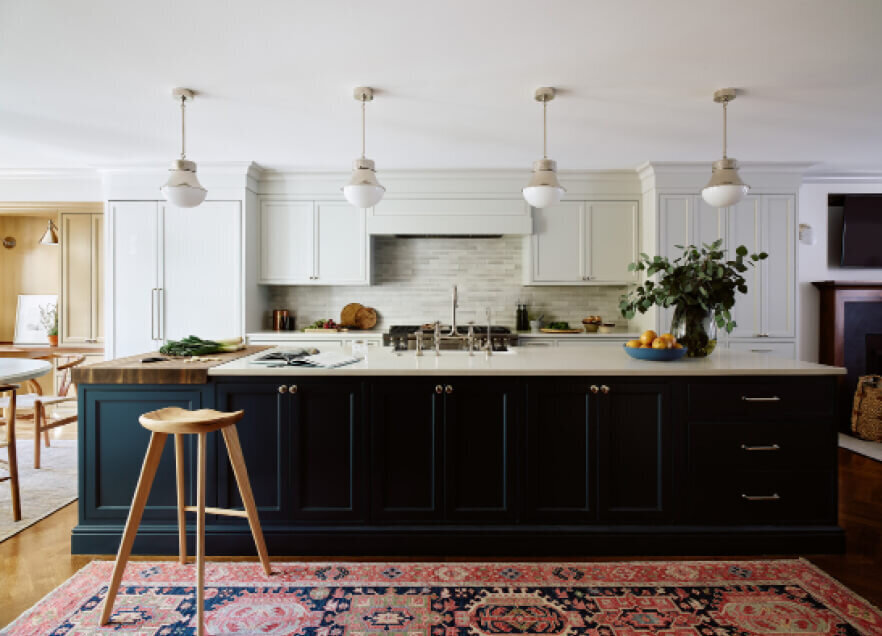 Boston Interior Designers designed a coffee station pantry with light grey cabinets, a navy blue interior, and a walnut butcher block island in a South End brownstone renovation.