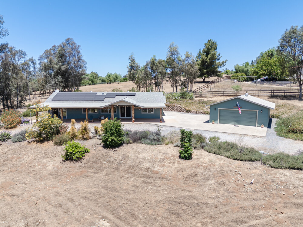 Aerial shot of front of home and detatched garage in Ramona, California