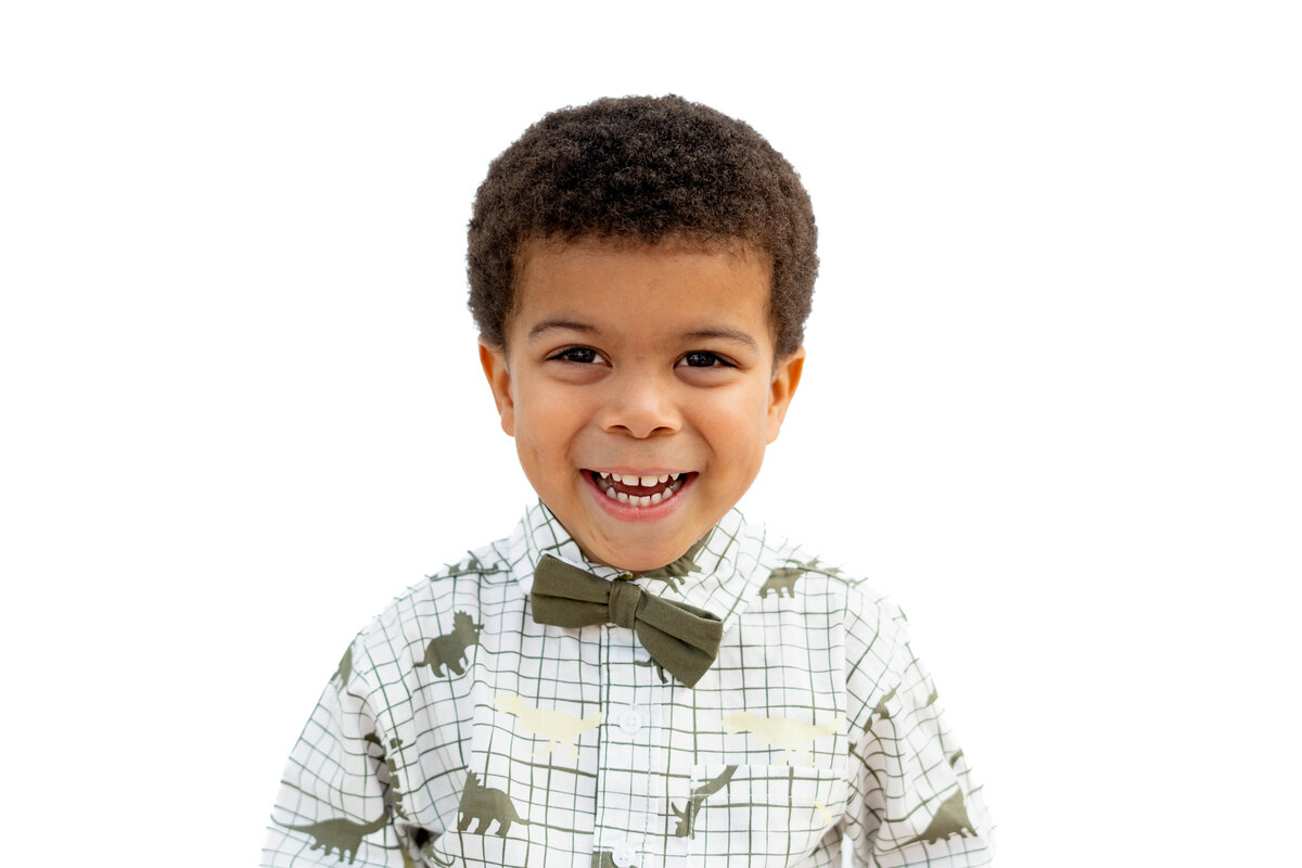 Little boy with green bow tie and big smile