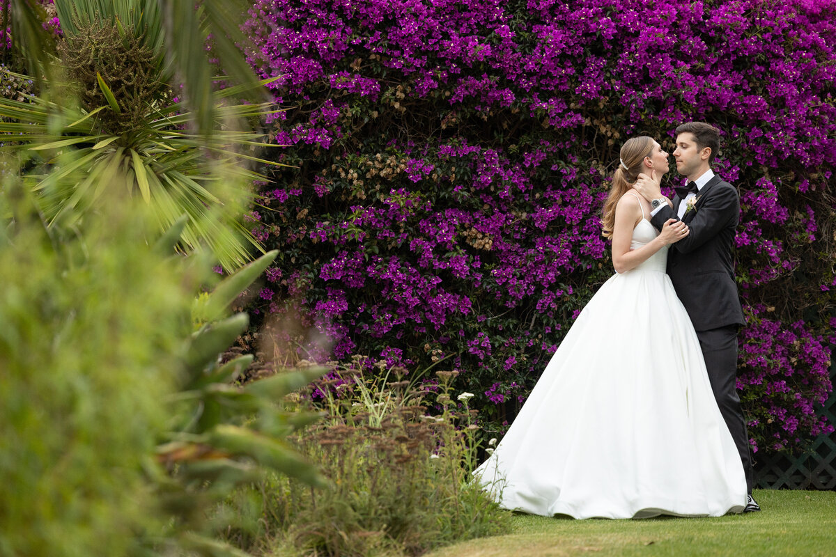 Bride and groom by the lawn at Bel Air Bay Club