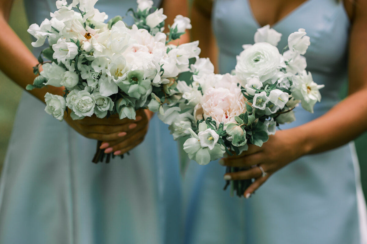 Close-up detail of bridesmaid bouquets with soft white and blush florals during a wedding at Old Edwards Inn in Highlands, North Carolina.