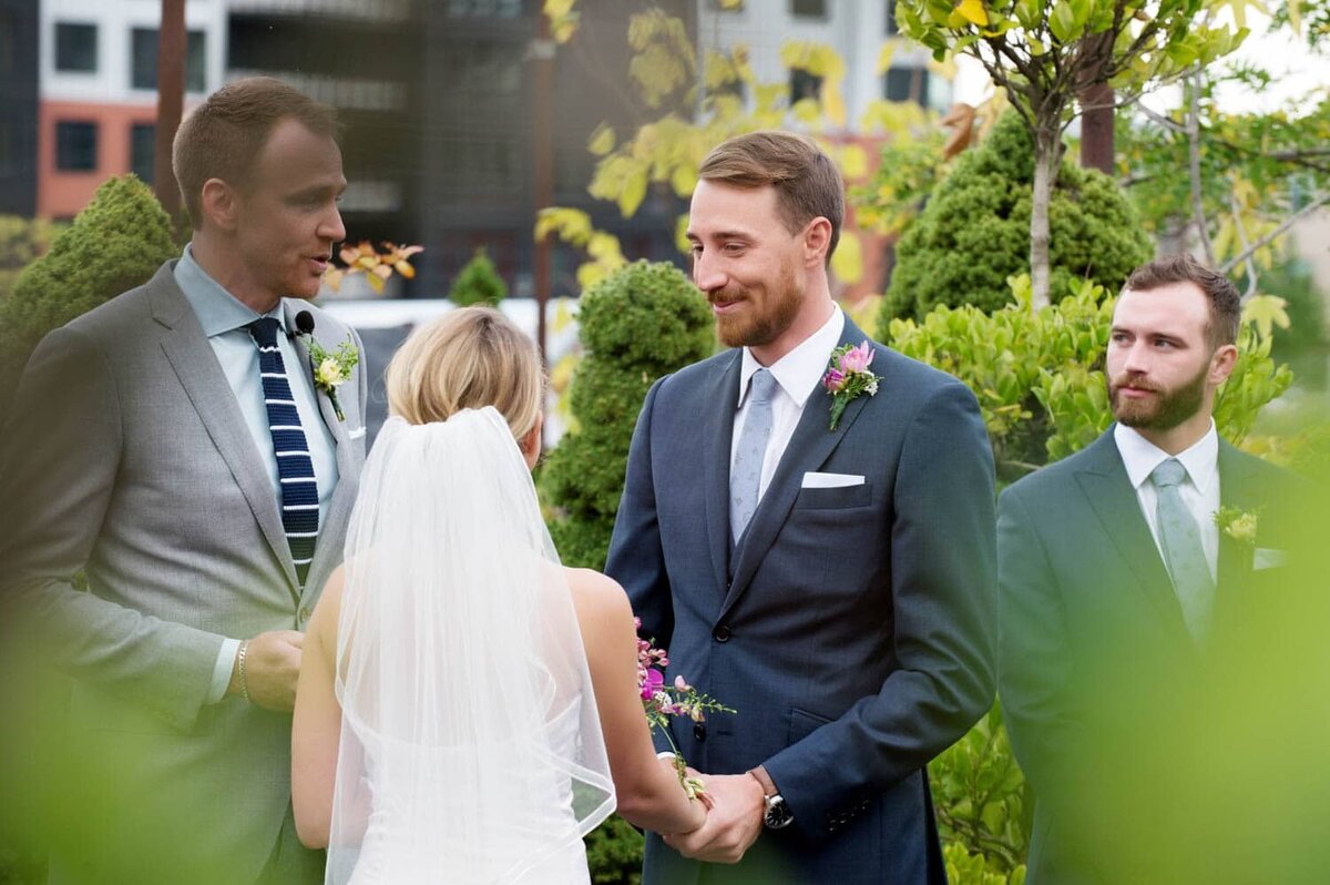 a groom gives a sweet look to his bride during their wedding vows
