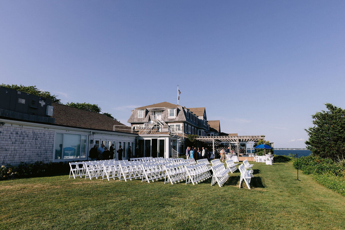 White chairs are arranged in rows for the wedding at Cape Cod Summer Tent in Massachusetts.