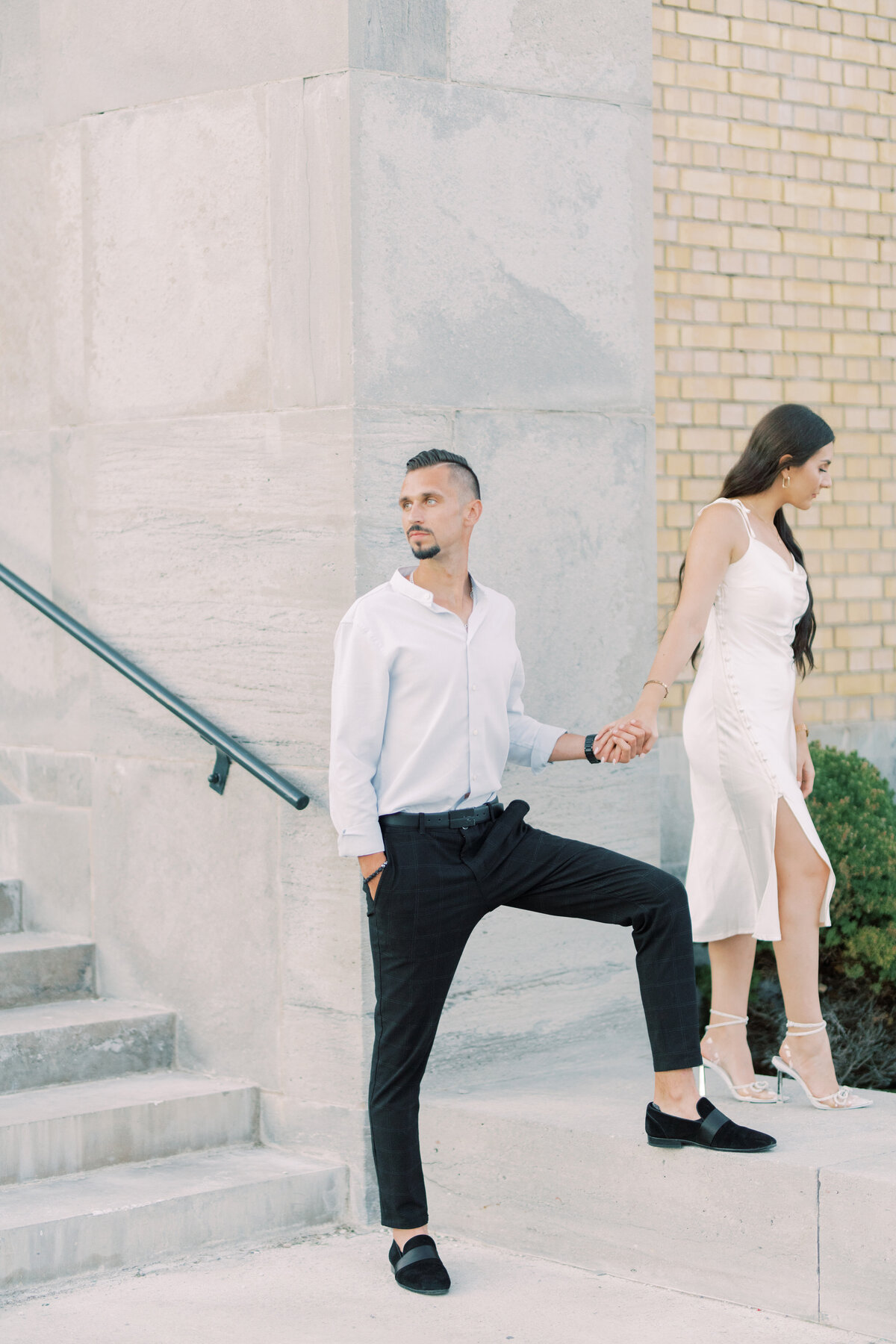 Groom lovingly guiding the bride up the stairs of Toronto’s RC Harris Water  Treatment Plant, a moment of support and connection