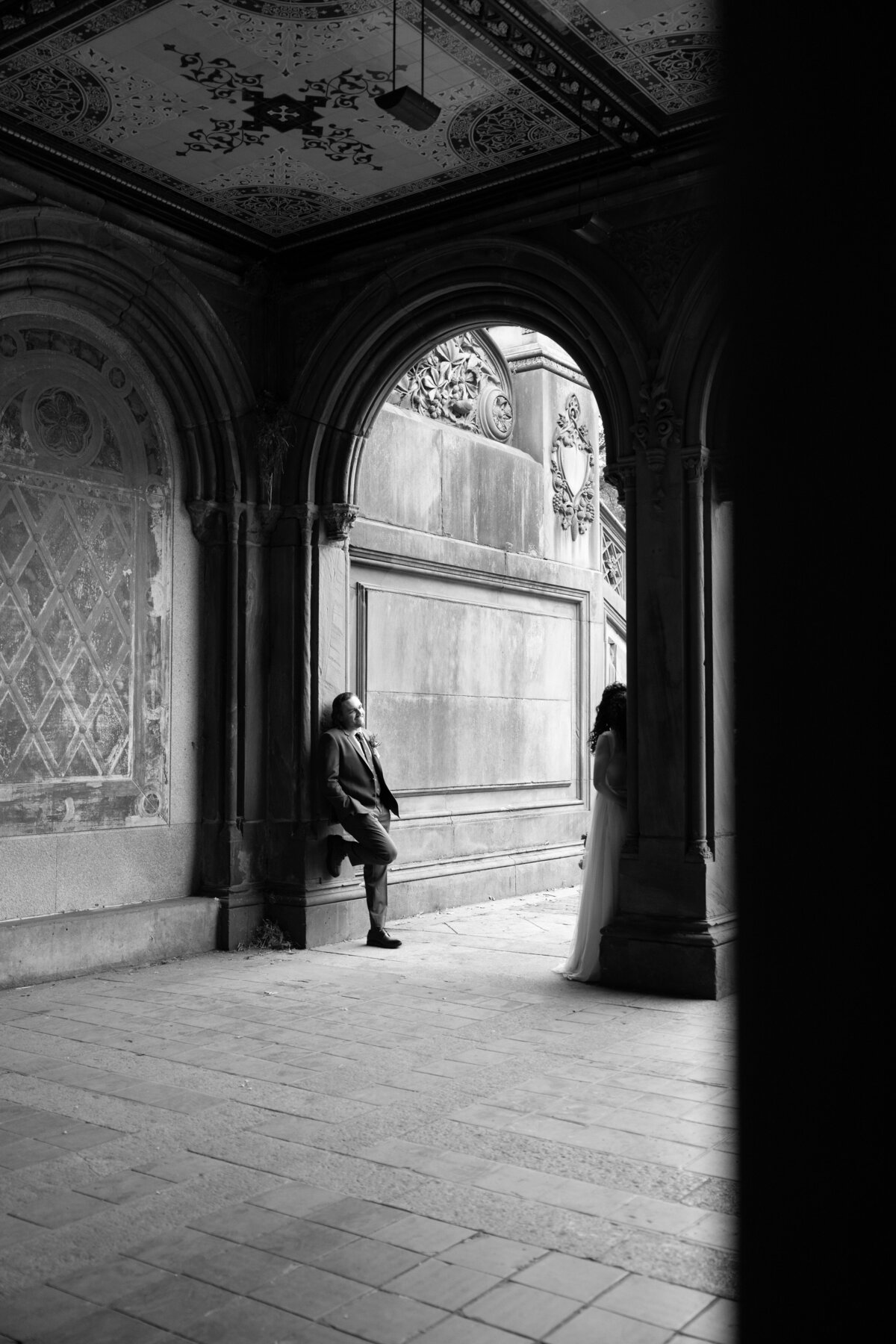 The couple sharing a tender moment beneath Central Park’s beautiful stone arches.