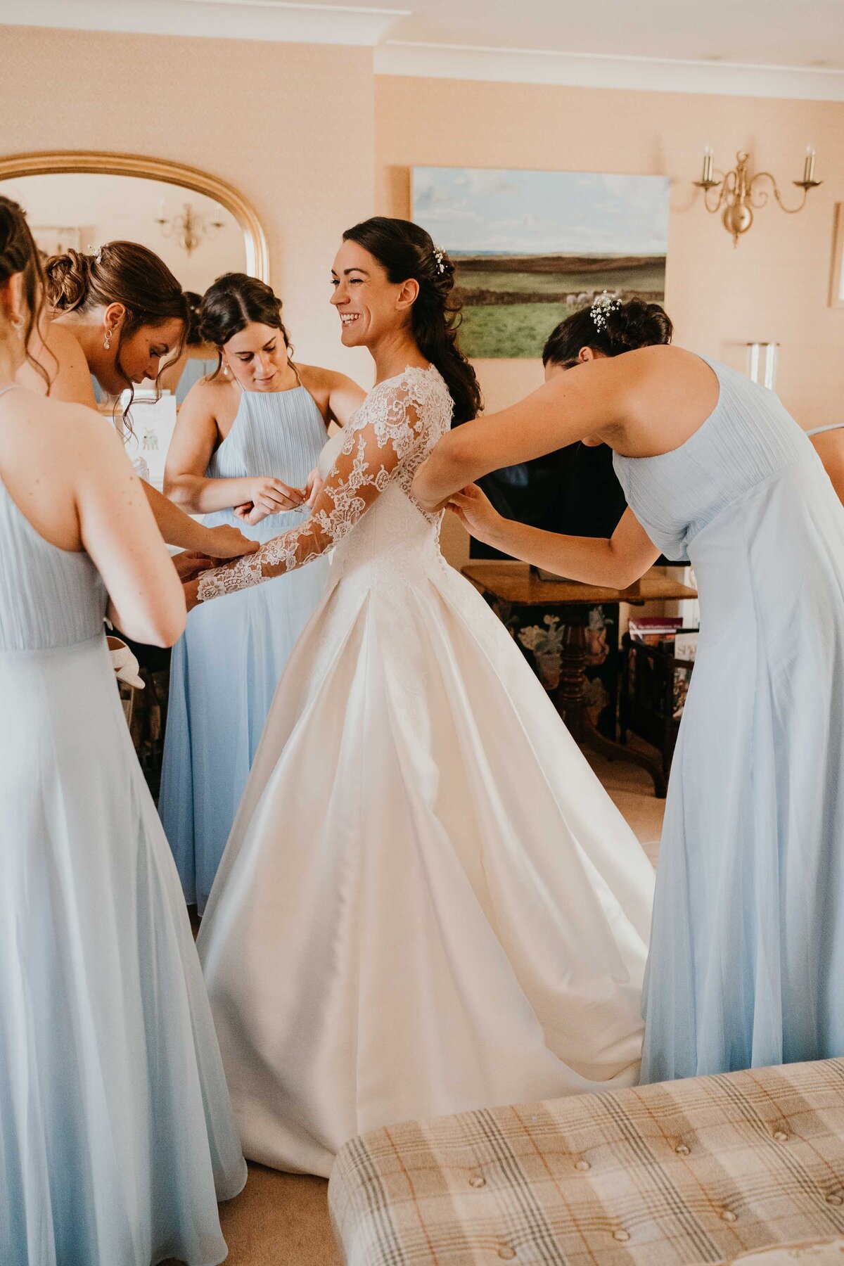 Bridesmaids helping bride get ready at Firle place wedding-1