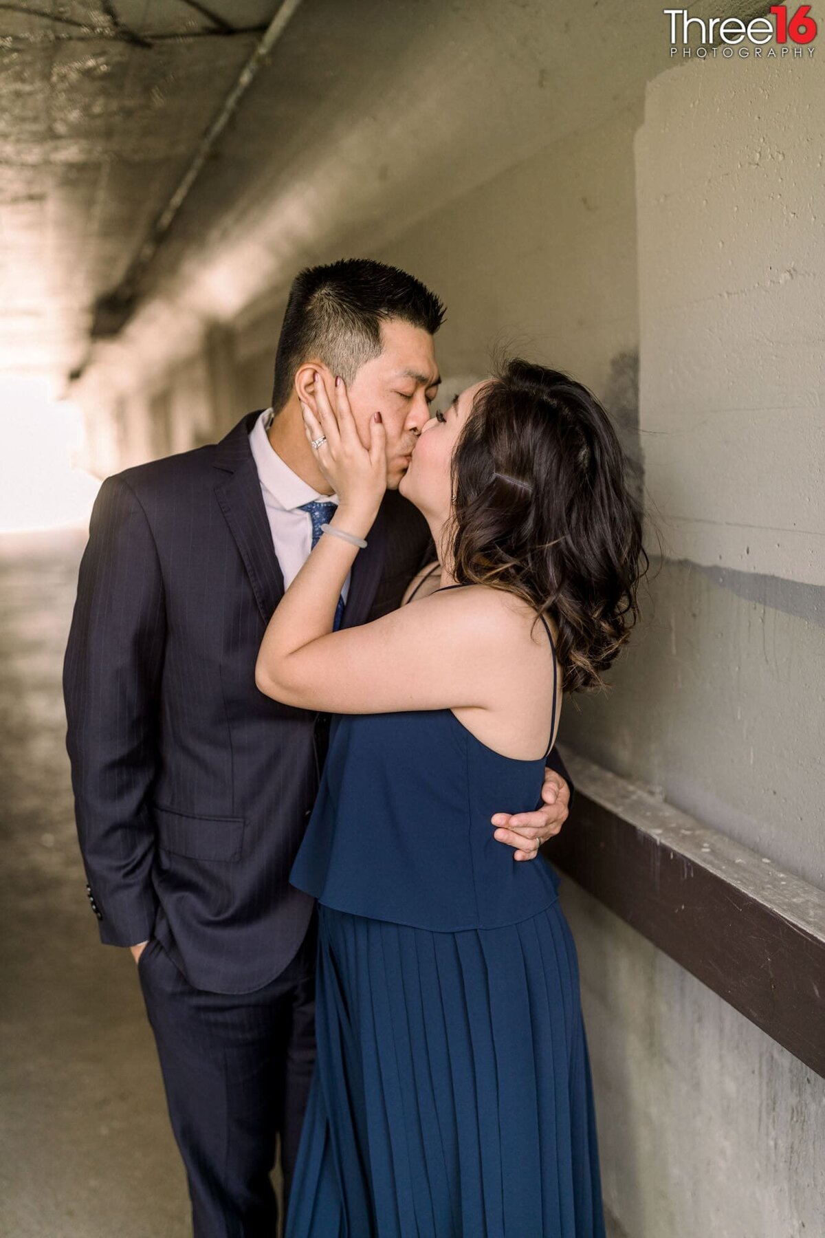 Engaged couple share an intimate kiss during engagement session