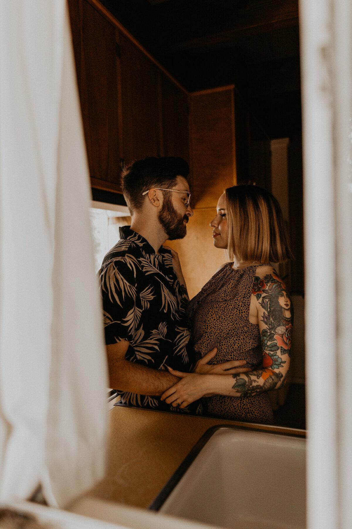 engaged couple hanging out in midcentury modern kitchen