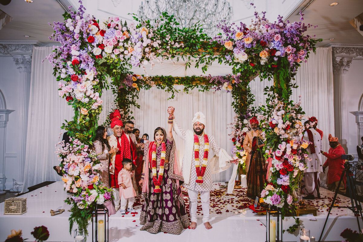 Indian bride and groom celebrate after the hindu wedding ceremony at the addison park in nj