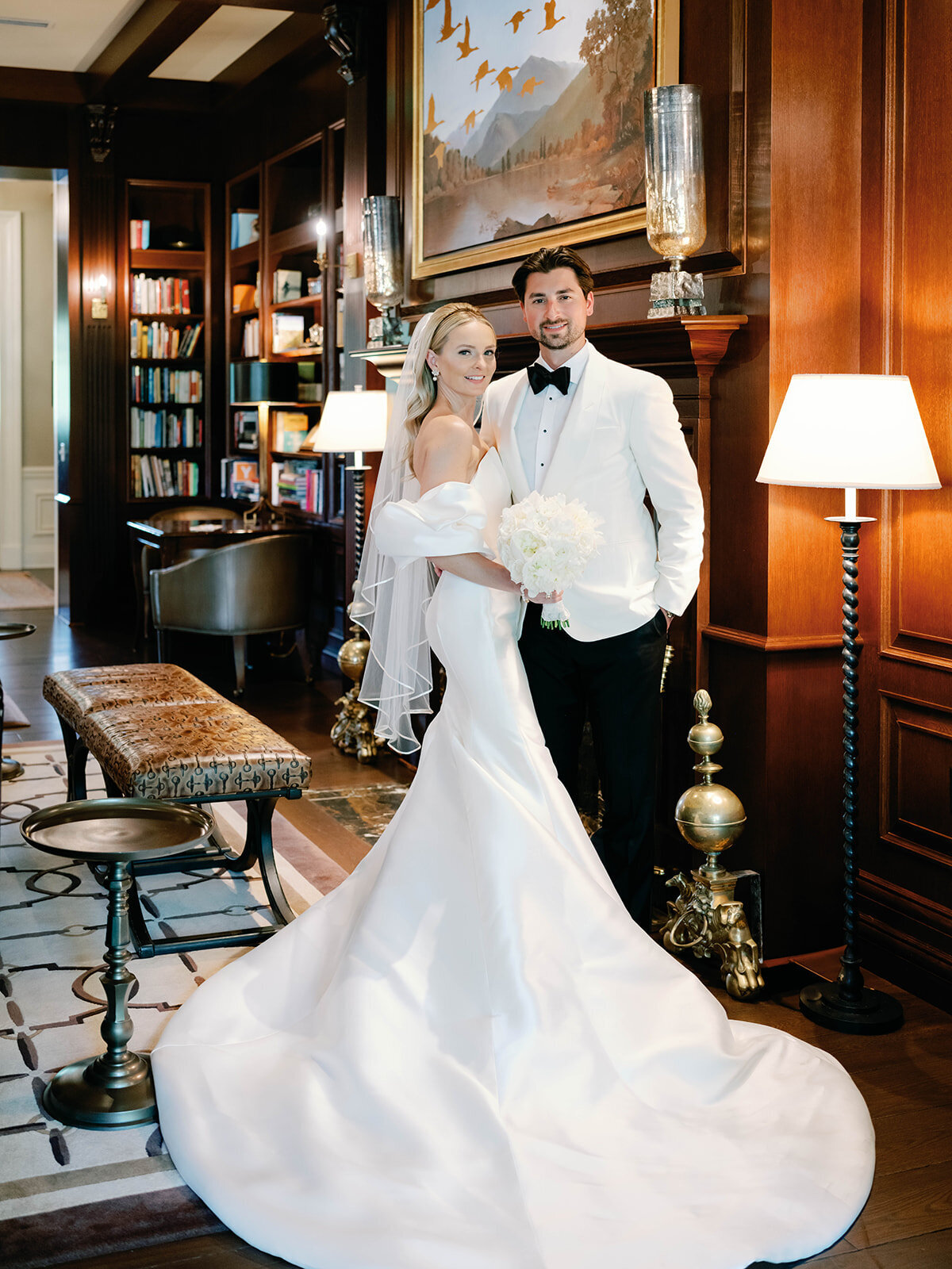 Couple pose by the fire place at salamander resort
