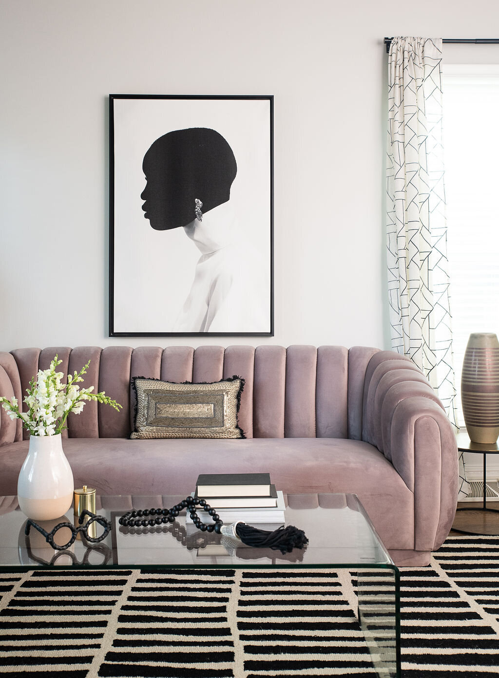 a coffee table, couch, and artwork in a living room