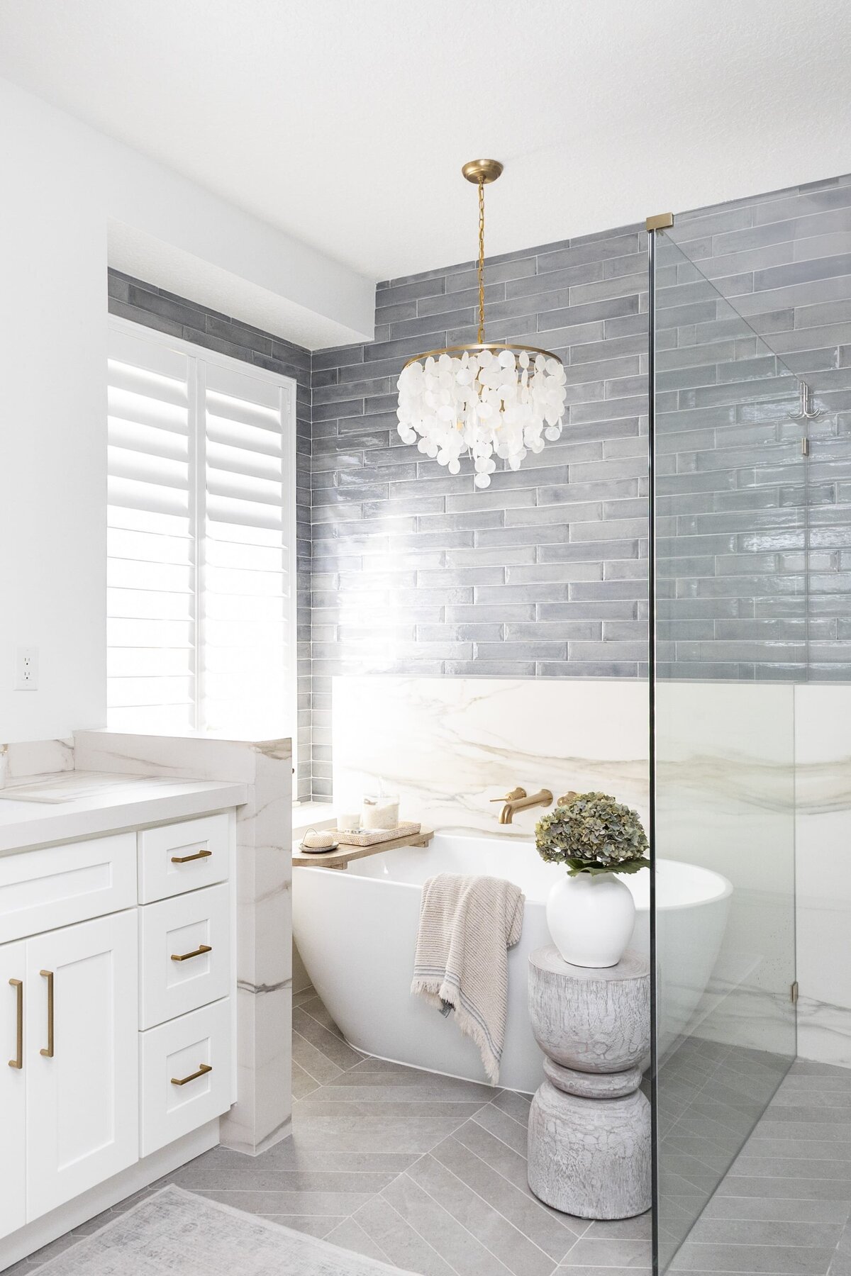 dewine design orlando interior designer contemporary coastal primary bathroom blue tile and standing rub with window
