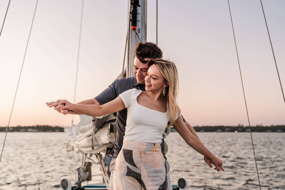 Orange-Beach-Bear-Point-Harbor-Sunset-Sail-Boat-Surprise-Proposal-Mobile-Fairhope-Birmingham-Alabama-Photographer-Videographer-Neeley-Griffin-Engaged-Portrait-Looking-At-Sunset-4