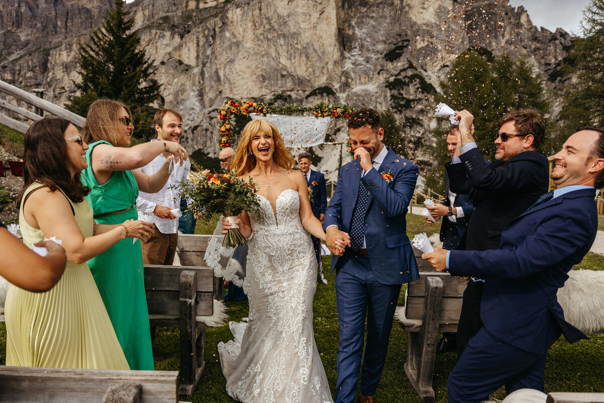 Bride and groom sharing laughter with family after Dolomites ceremony