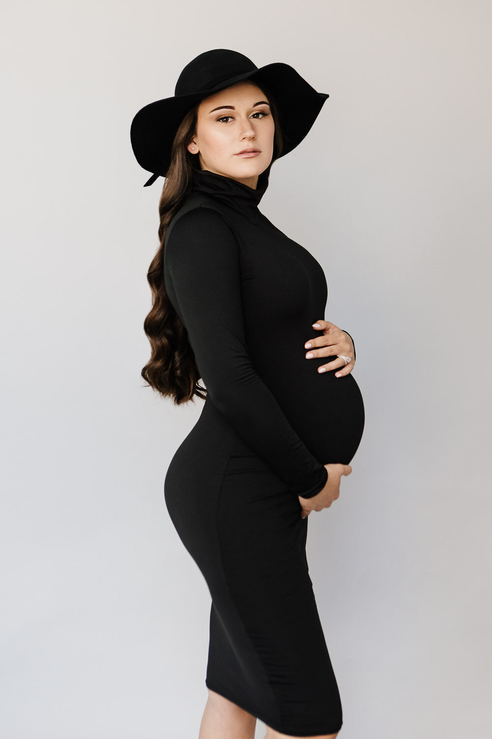 Beauty portrait of pregnant woman in black bodycon dress