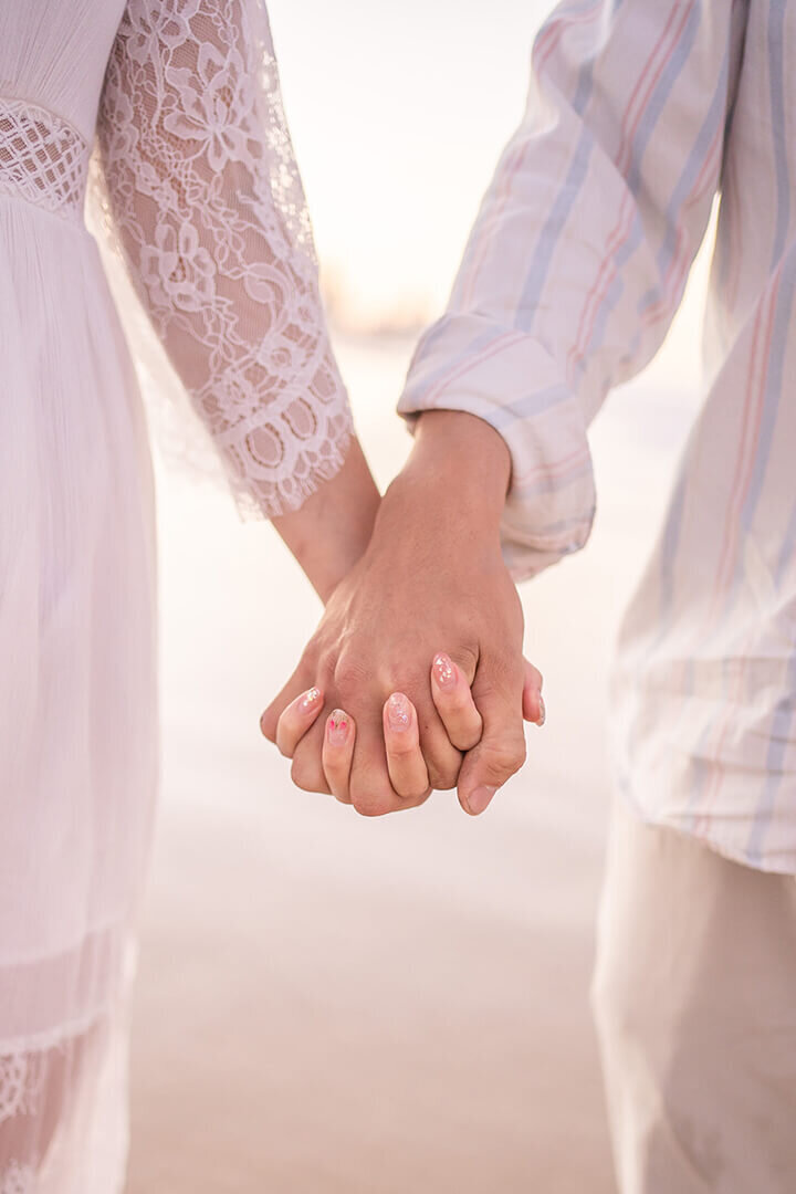 couple holding hands on miami beach gold coast celebrating annivesary