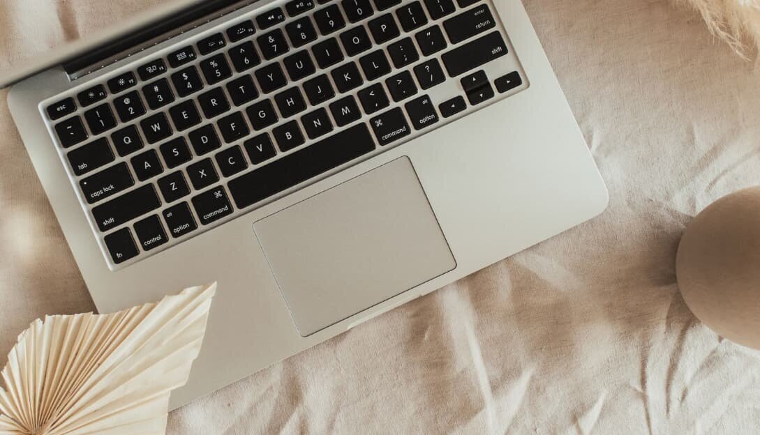 Laptop on a beige background, illustrating the call to action 'Your Story Starts Here' for website and course creation.
