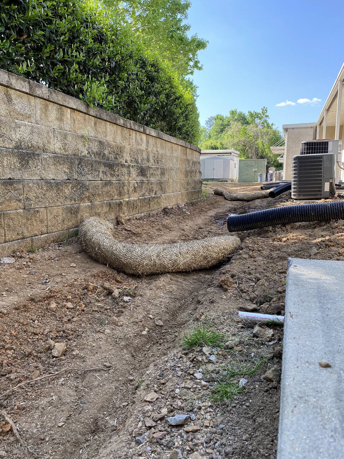 large-hose-on-dirt-floor-next-to-stone-wall