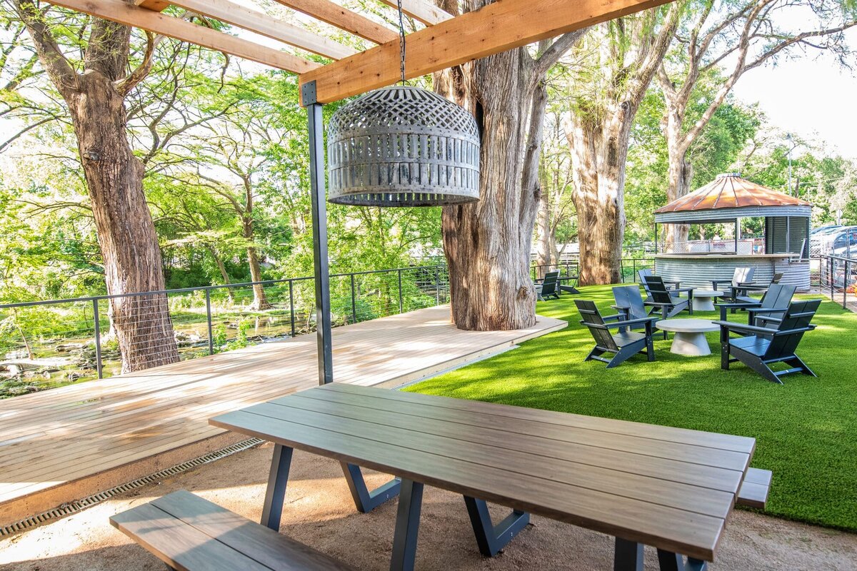 Exterior of Creekhouse with picnic tables and large trees