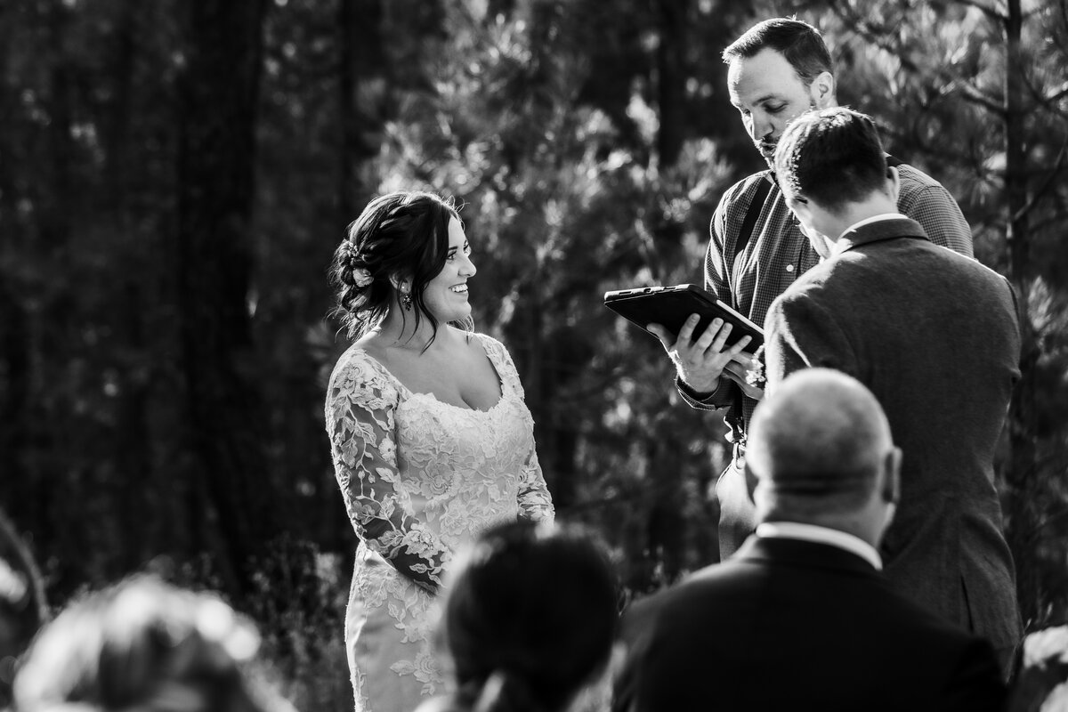 Spokane wedding in Colbert Wa ceremony, bride looking at officiant and groom looking at officiant as well.