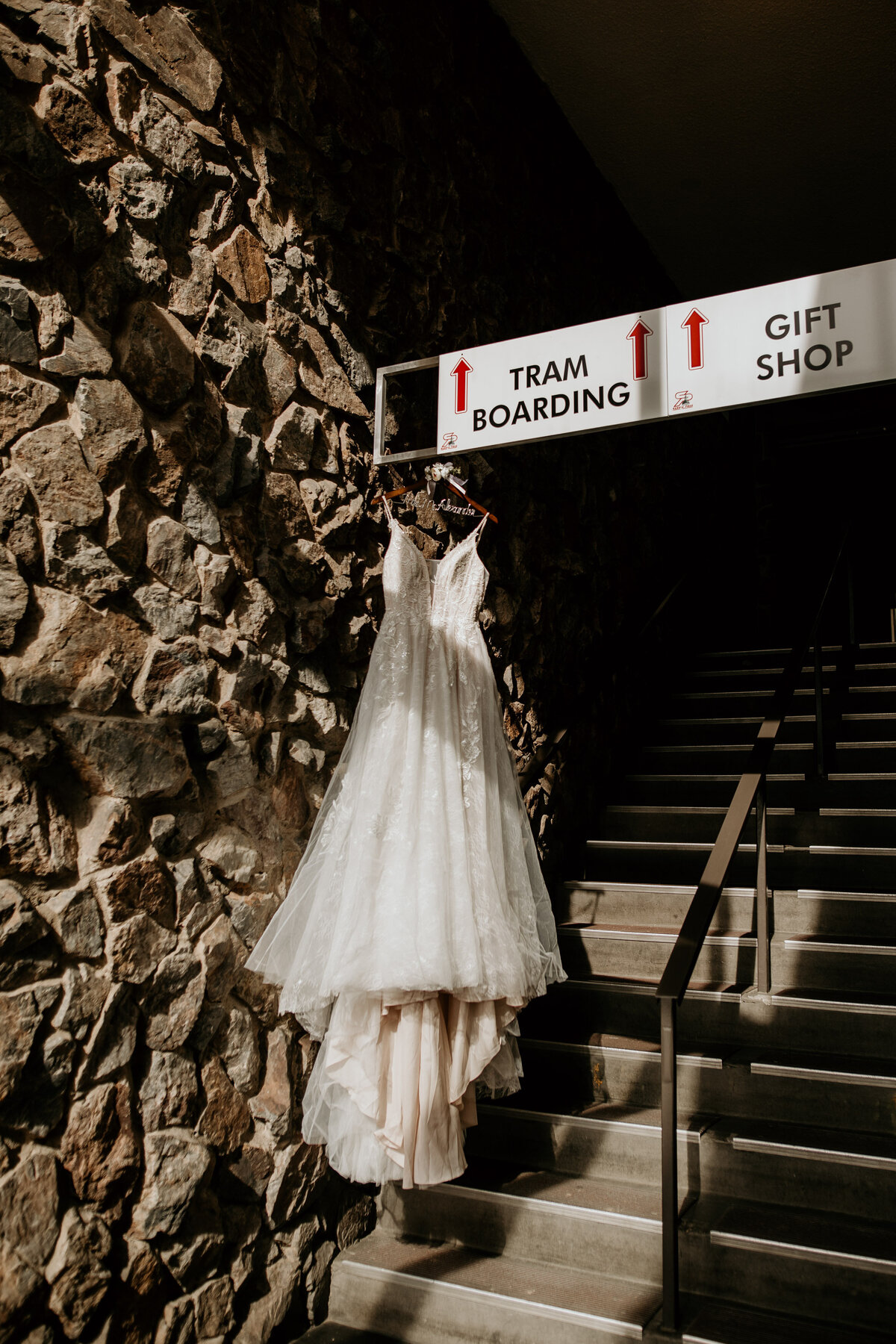 lace wedding dress hanging in sandia peak tram terminal