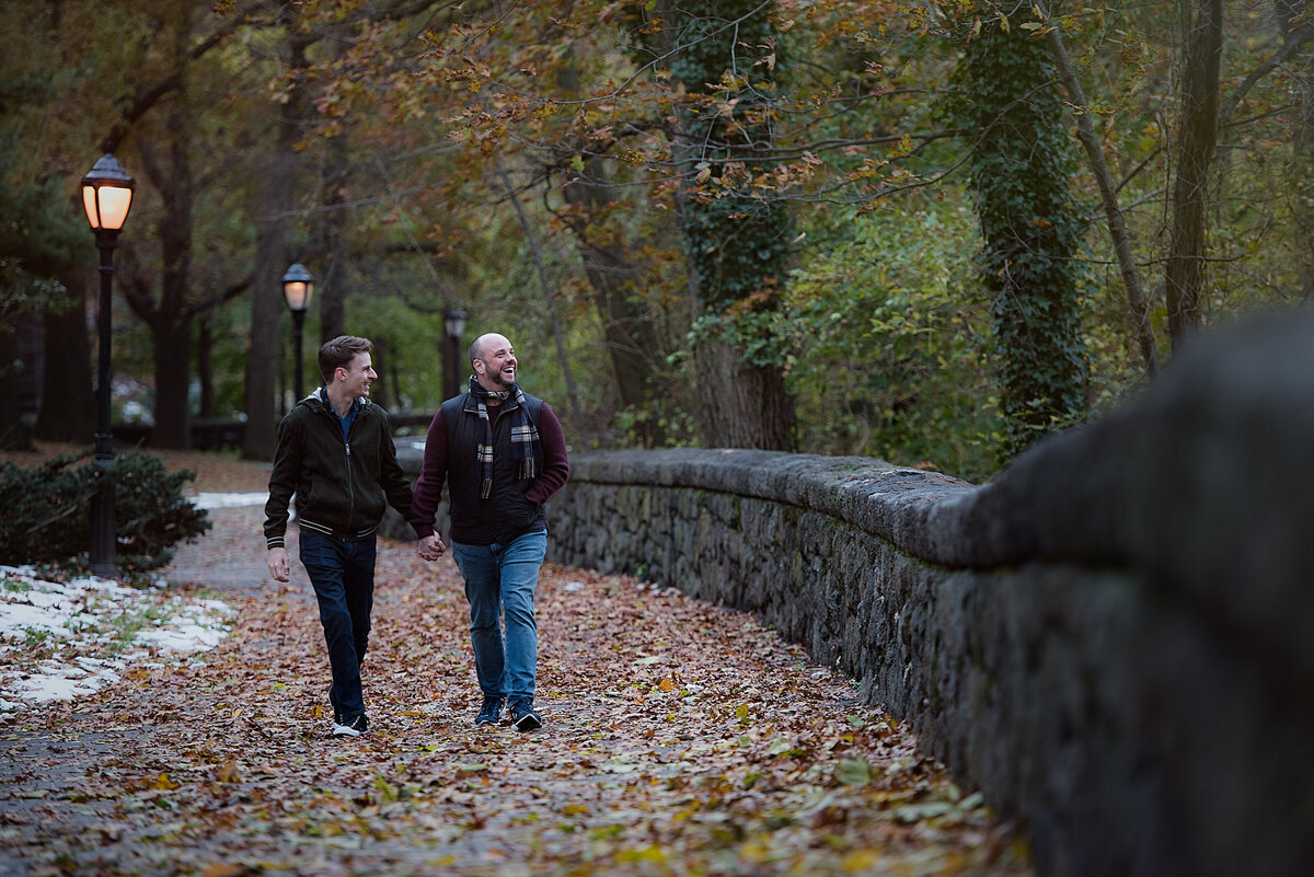A couple holding hands and walking in a park