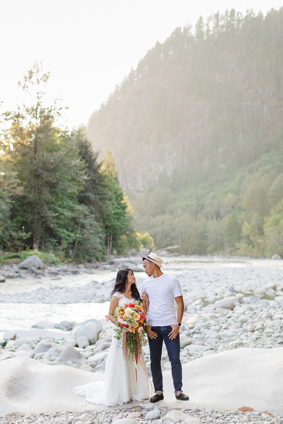 Bride-and-groom-share-a-moment-at-their-mountain-elopement-next-to-the-river-near-Seattle-WA-photo-by-Joanna-Monger-Photography